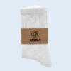 Ein Paar weiße Socken, die mit einer braunen Papierbanderole mit dem schwarzen "STEAM"-Logo verpackt sind.