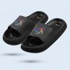 A pair of black flip-flops with thick platform soles and a dotted texture. They feature a multicolored circular logo on the upper strap and the word “STEAM” in colorful lettering on the heel area.