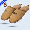 A brown slipper with a fluffy brown lining. The black lettering “RITTAL” is printed on the front.