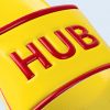 A close-up of the strap on the yellow sandal. You can see the texture of the synthetic material and the detail of the word “HUB” written in high-quality 3D embossed red letters, outlined in red.