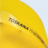 A macro close-up of the strap of a yellow flip-flop, highlighting the precision of the black print of the letters “TOSKANA THERME.”