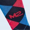 Close-up of the geometric diamond pattern in blue and red on a black background, with the “M2.” logo integrated into the fabric design.