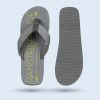 Composition showing a Yara flip-flop from above with the hotel’s branding and a view of the gray rubber sole with a non-slip horizontal line pattern.